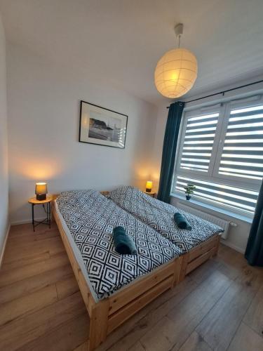 Postel nebo postele na pokoji v ubytování Apartament Bazylek, miejsce parkingowe w garażu podziemnym