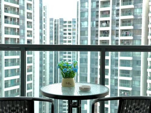 a table with a vase of flowers on a balcony at R&F Seine Region in Johor Bahru