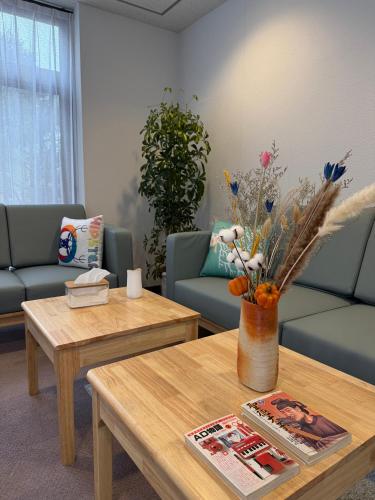 a living room with a vase of flowers on a table at Sansui Resorts Yamanakako in Yamanakako
