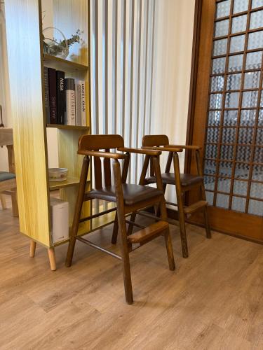 two chairs and a table and a book shelf at Sansui Resorts Yamanakako in Yamanakako