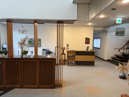 an empty lobby with a reception desk and stairs at Sansui Resorts Yamanakako in Yamanakako