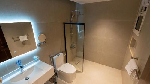 a bathroom with a shower and a toilet and a sink at Brzeen Hotel Riyadh in Riyadh