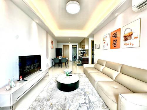 a living room with a couch and a tv at R&F Seine Region in Johor Bahru