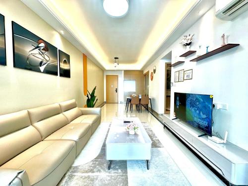 a living room with a couch and a tv at R&F Seine Region in Johor Bahru