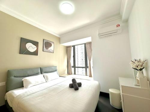 a bedroom with a bed with a teddy bear on it at R&F Seine Region in Johor Bahru