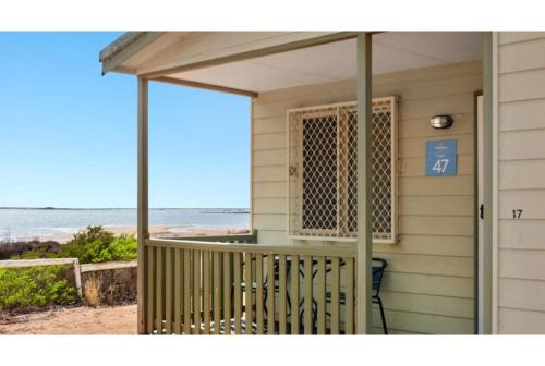 a screened in porch with a view of the beach at Discovery Parks - Port Hedland in Port Hedland