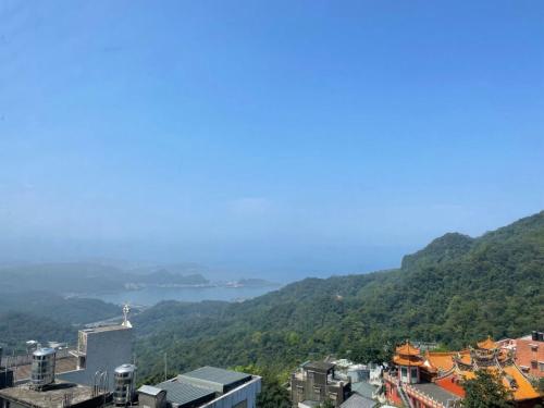 a view of a city with a lake in the distance at Old Street Seaview Homestay in Jiufen