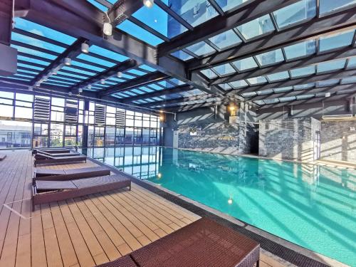 a large swimming pool in a building at The Matrix One - Luxury free Gym&Pool in Hanoi