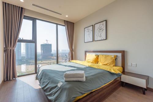 a bedroom with a bed and a large window at The Matrix One - Luxury free Gym&Pool in Hanoi