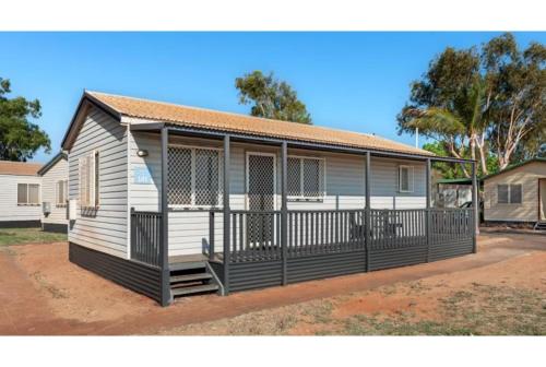a small white house with a porch at Discovery Parks - Port Hedland in Port Hedland