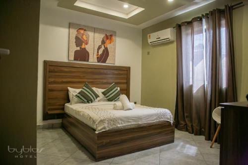 a bedroom with a bed in a room at Byblos Hotel-Sky Osu in Accra