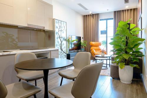 a kitchen and dining room with a table and chairs at The Zenpark Tower - Vinhomes Ocean Park in Gia Lâm Pho
