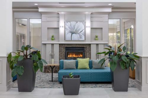 a living room with a couch and a fireplace at Hilton Garden Inn Winston-Salem/Hanes Mall in Winston-Salem