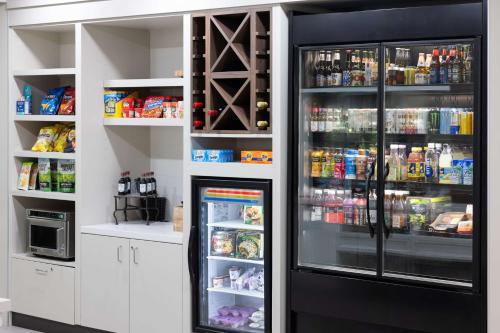 a refrigerator with its door open in a kitchen at Hilton Garden Inn Winston-Salem/Hanes Mall in Winston-Salem