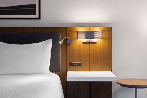 a bedroom with a bed and a table and a lamp at Hilton Garden Inn Winston-Salem/Hanes Mall in Winston-Salem