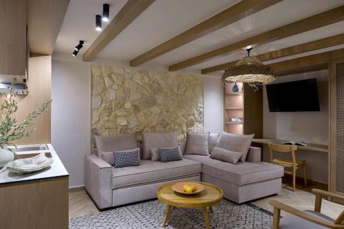 a living room with a couch and a table at Mirabello Bay Luxury Resort in Agios Nikolaos