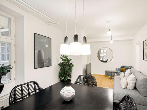 a living room with a table and a couch at Sanders Tivoli 1- Lovely 2-Bdr Apt near Tivoli in Copenhagen