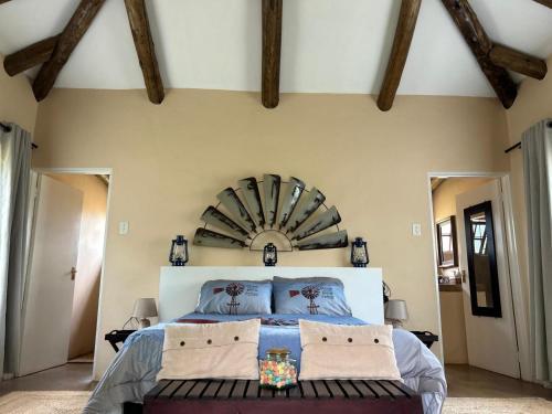 a bedroom with a large bed with a large mirror at The Windmill Country Retreat in Hazyview