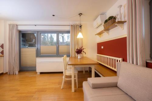 a living room with a table and a couch at Lakeside Apartments Bled in Bled