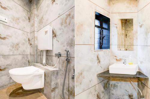 a bathroom with a toilet and a sink at Super Collection O Ghodbunder Road Formerly Sanwith Residency in Sasupāda