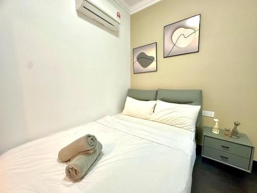 a bedroom with a bed with a towel on it at R&F Seine Region in Johor Bahru