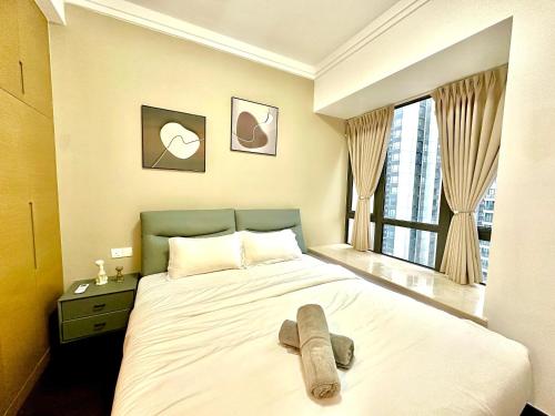 a bedroom with a large bed with a large window at R&F Seine Region in Johor Bahru