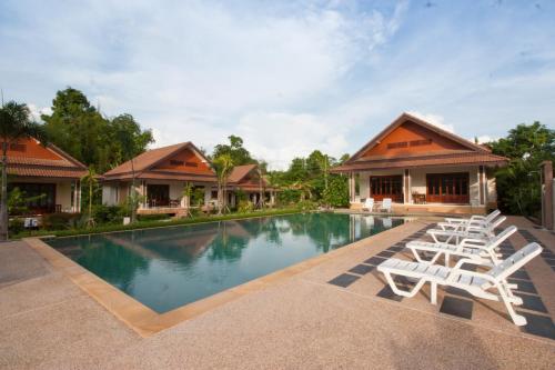 a pool at the resort with lounge chairs at Oscar Villa Aonang Krabi in Ao Nang Beach