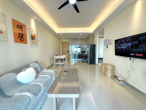 a living room with a couch and a table at R&F Seine Region in Johor Bahru