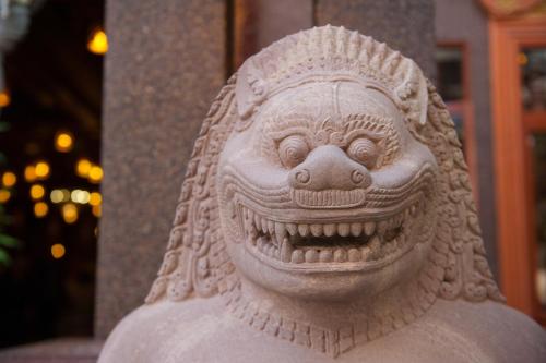 a stone statue of a lion with its mouth open at Okay Boutique Hotel in Phnom Penh