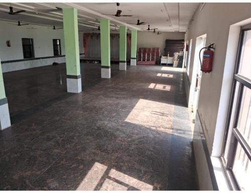 an empty hallway of a building with green columns at Hotel Yoran Inn, Baldeo in Baldeo