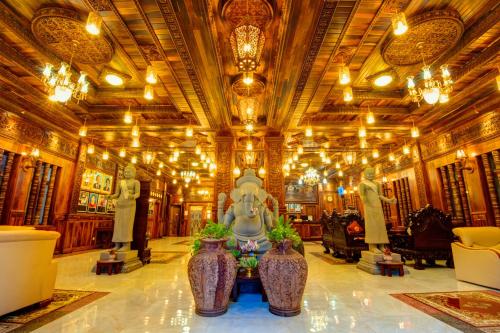 a lobby with vases and chandeliers in a building at Okay Boutique Hotel in Phnom Penh