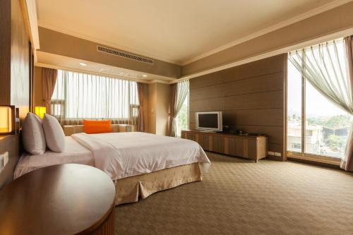 Кровать или кровати в номере F Hotel - Chiayi