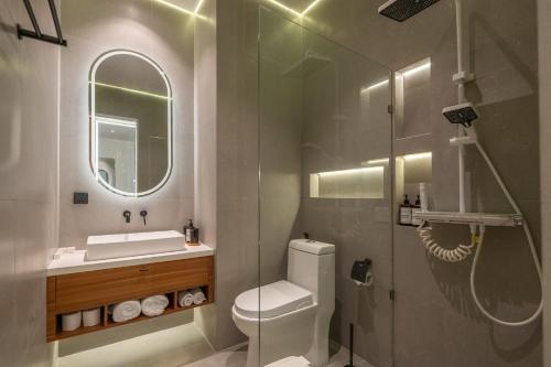 a bathroom with a toilet and a sink and a mirror at Balidian II Residence Loft 2 1 BR in Pesanggaran