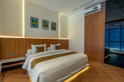 a bedroom with a large bed and a large window at Balidian II Residence Loft 2 1 BR in Pesanggaran