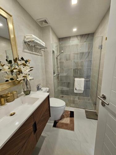 a bathroom with a sink and a toilet and a shower at The City Condo Near Central Fest Phuket, Pool view in Ban Sam Kong