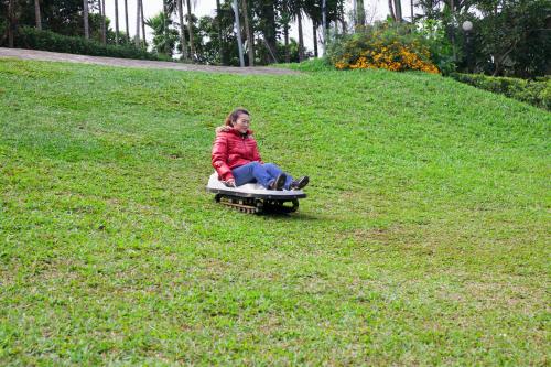 a woman sitting on a board in the grass at F Hotel - Chiayi in Fanlu