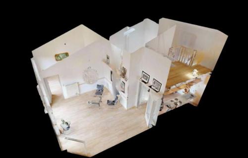 an overhead view of a living room with white walls at Ferienwohnung Seeblick Timmel in Großefehn 