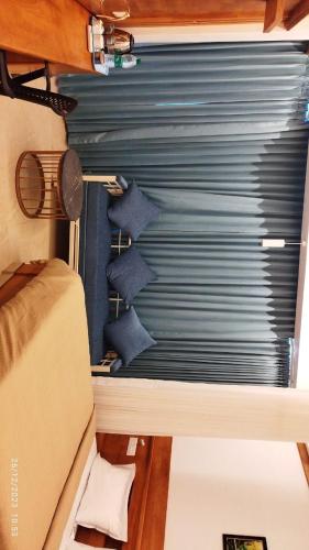 a room with a blue garage door with a window at Sandcastle in Varkala