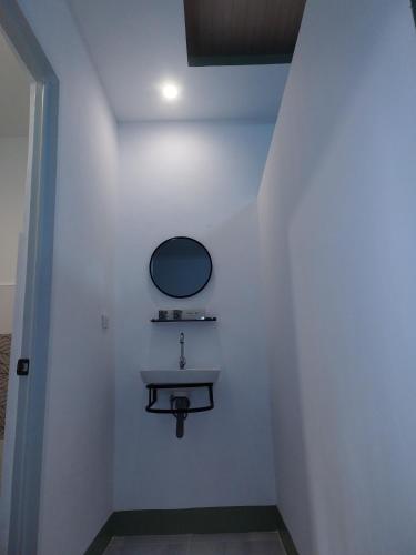 a bathroom with a sink and a mirror on the wall at GREENSPACE in Panglao