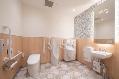 a bathroom with a toilet and a sink at Just Inn Premium Toyohashi Station in Toyohashi