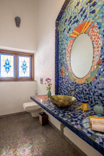a bathroom with a sink and a mirror at The Inner Temple, Moira in Mapusa