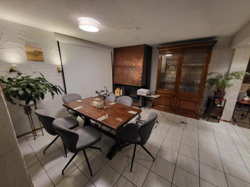 a dining room with a wooden table and chairs at Hotel Schönblick in Bad Herrenalb