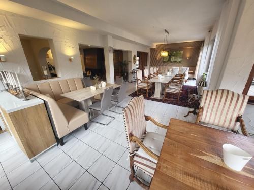 a restaurant with tables and chairs and a dining room at Hotel Schönblick in Bad Herrenalb