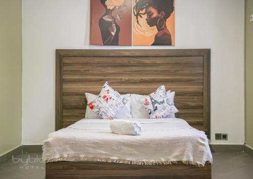 a bedroom with a large bed with pillows at Byblos Hotel-Sky Osu in Accra