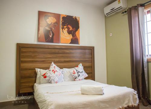 a bedroom with a large bed with pillows at Byblos Hotel-Sky Osu in Accra