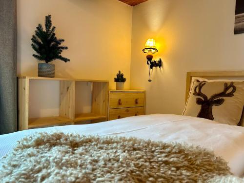 a bedroom with a bed with a dresser and a christmas tree at Edelweiss Lodge Lachtal I Self Check-in in Lachtal