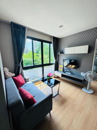 a living room with a couch and a fireplace at The private paradise 2 in Pattaya North