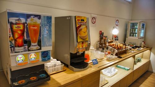 a store with a counter with drinks on it at Just Inn Matsusaka Station in Matsuzaka