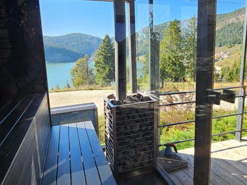 a porch with a view of a lake and mountains at Lake Forest Dedinky in Dedinky