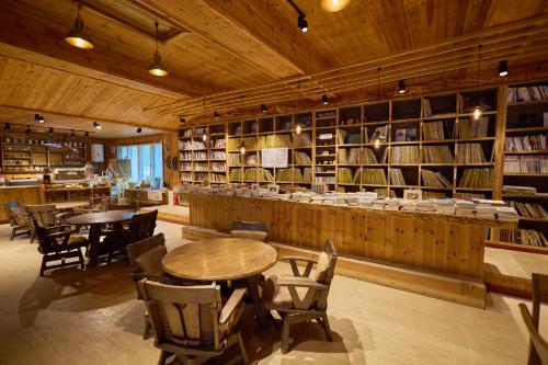 a library with tables and chairs and shelves of books at Manhae Maeul in Inje